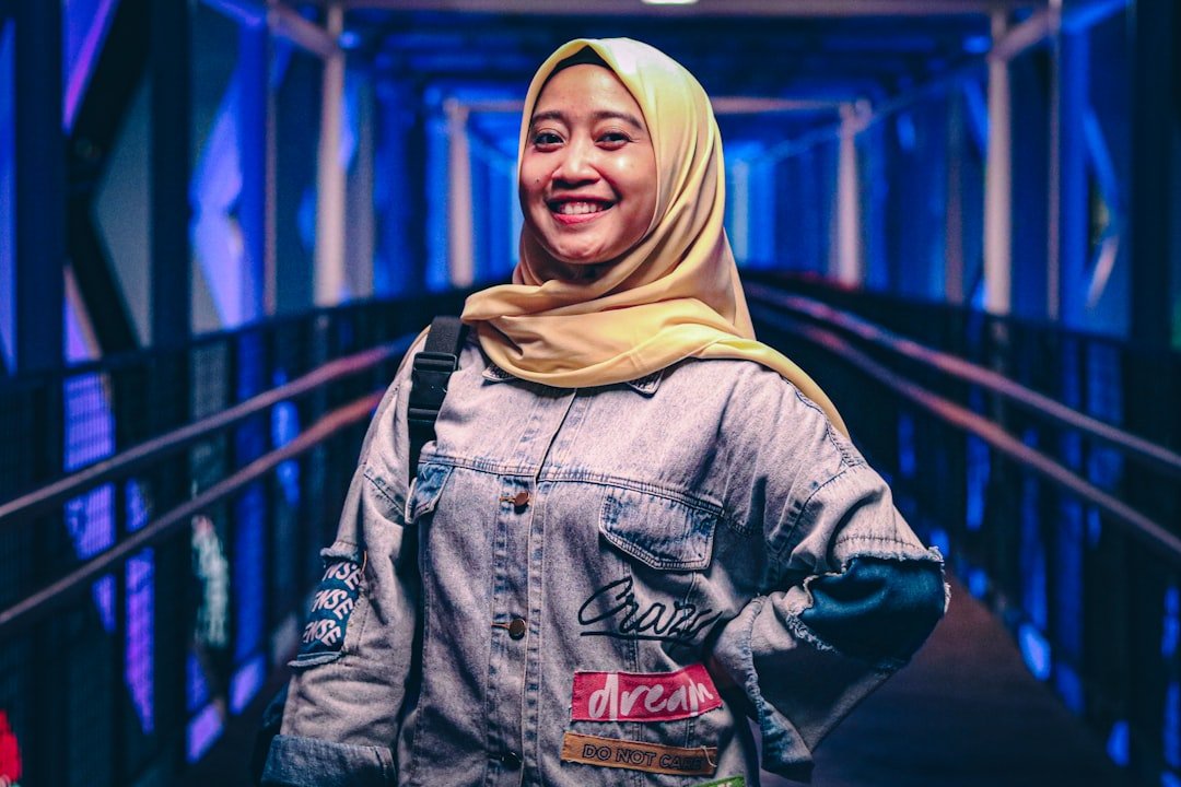 young-woman-in-hijab-standing-on-illuminated-walkway-9v0rwk86ins